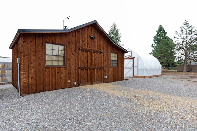 view of greenhouse with fence