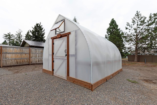 view of greenhouse with fence