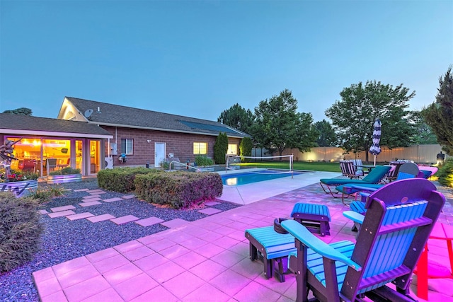 view of swimming pool with fence and a patio