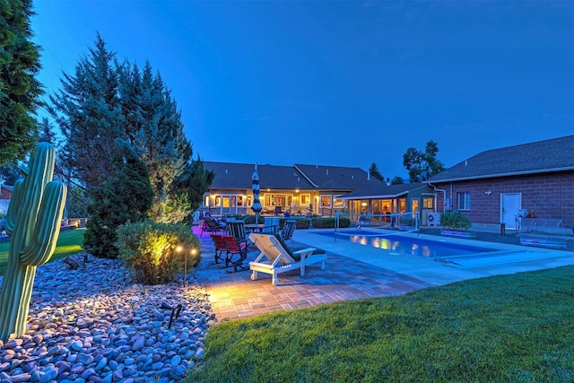 pool with a patio and a yard