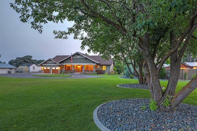 view of front of property with driveway, fence, and a front yard