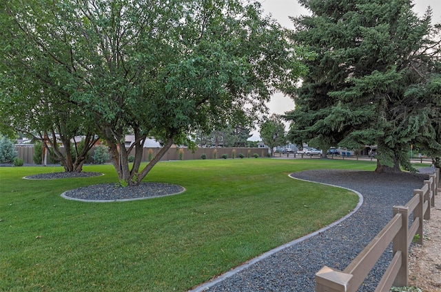 view of property's community with a yard and fence