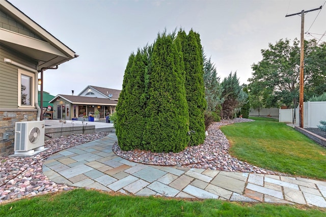 view of yard featuring ac unit, a patio area, and fence