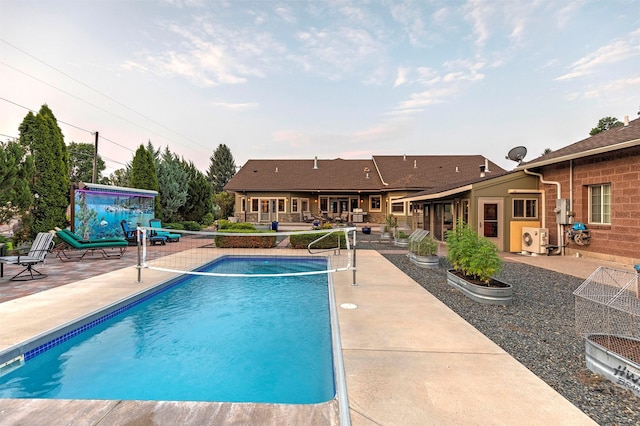 outdoor pool with a patio area