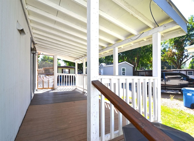 wooden terrace featuring a storage unit