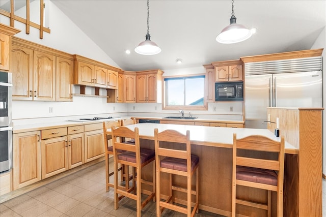 kitchen featuring pendant lighting, a breakfast bar area, light countertops, vaulted ceiling, and black microwave