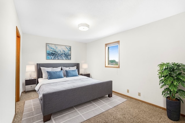 carpeted bedroom featuring baseboards