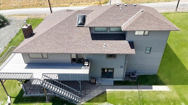 back of property featuring roof with shingles, a chimney, a deck, cooling unit, and stairs