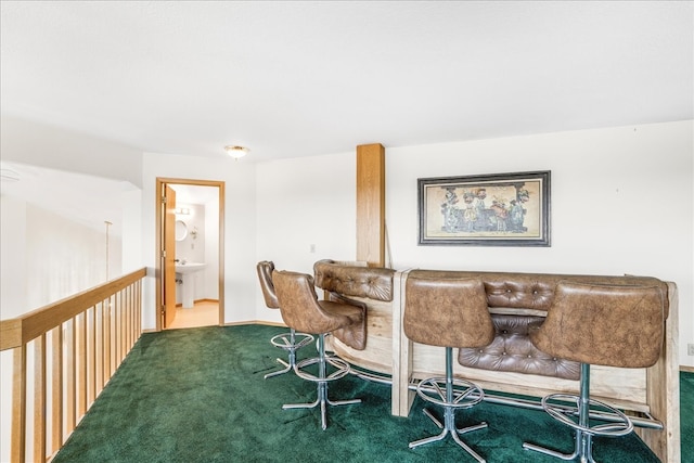 carpeted dining area featuring a sink