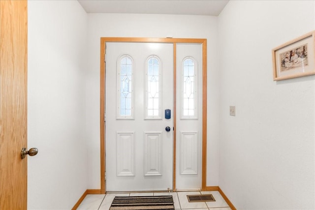 entrance foyer featuring light tile patterned flooring, visible vents, and baseboards