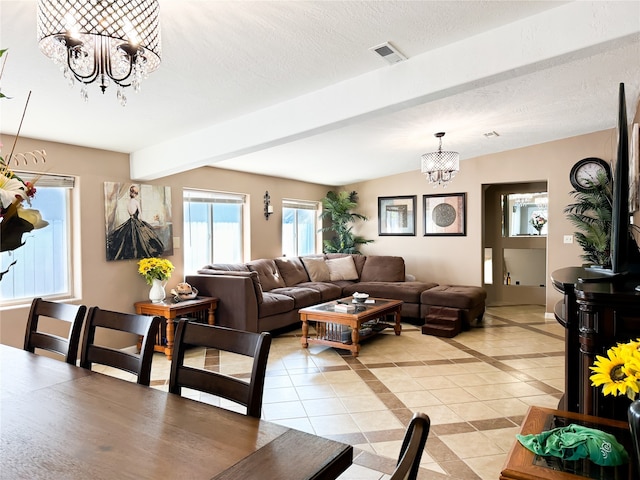 living room featuring beam ceiling, an inviting chandelier, light tile patterned floors, and a textured ceiling