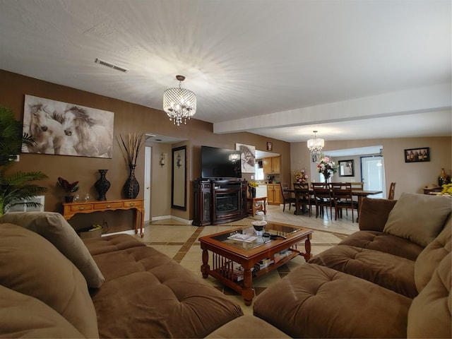 living area with a notable chandelier, visible vents, baseboards, and light tile patterned flooring