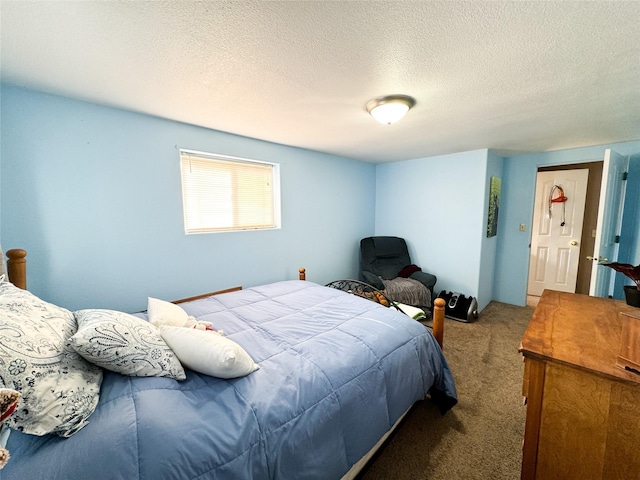 bedroom with carpet and a textured ceiling