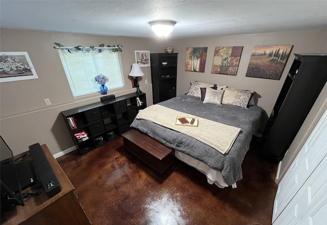 bedroom with a textured ceiling and finished concrete floors