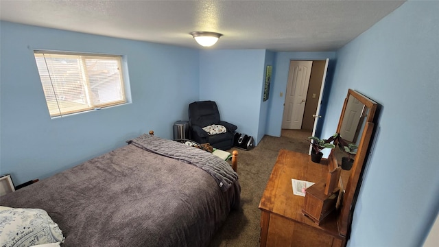 carpeted bedroom featuring radiator and a textured ceiling