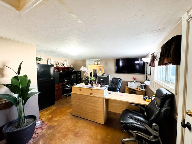 office with a textured ceiling and concrete floors