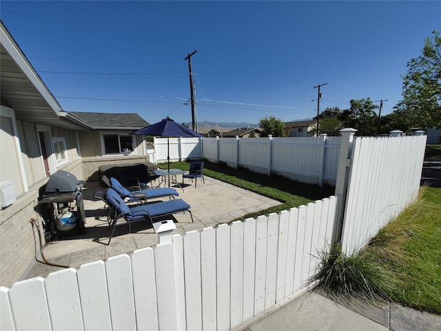 view of patio / terrace with a grill and a fenced backyard