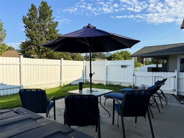 view of patio with outdoor dining space and fence