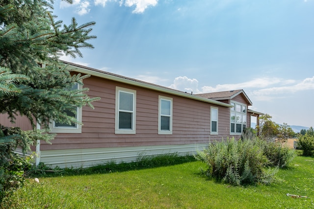 view of home's exterior with a yard