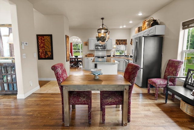 dining room with sink and light hardwood / wood-style flooring