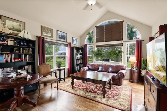 interior space with ceiling fan, high vaulted ceiling, light hardwood / wood-style flooring, and a healthy amount of sunlight