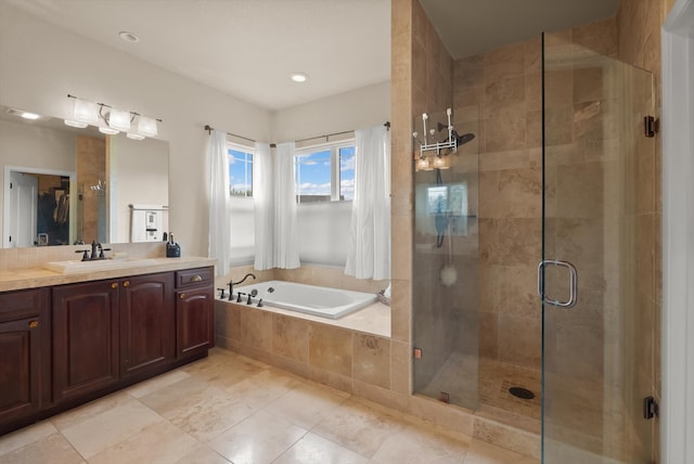 bathroom with tile patterned floors, separate shower and tub, and vanity