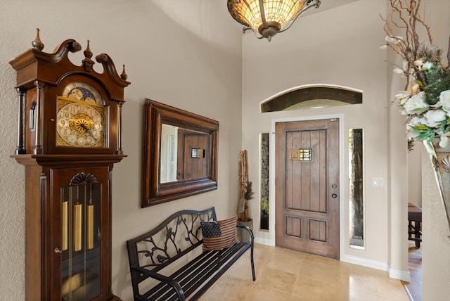 foyer with light tile patterned floors and a high ceiling