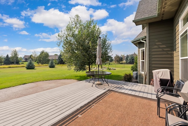 wooden terrace with a patio area and a yard