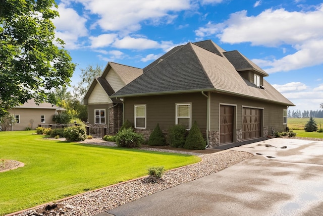 view of home's exterior featuring a garage and a yard