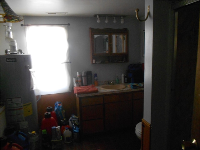 467 Cooper Ln, Hamilton, MT 59840 - bathroom with water heater, vanity, and toilet