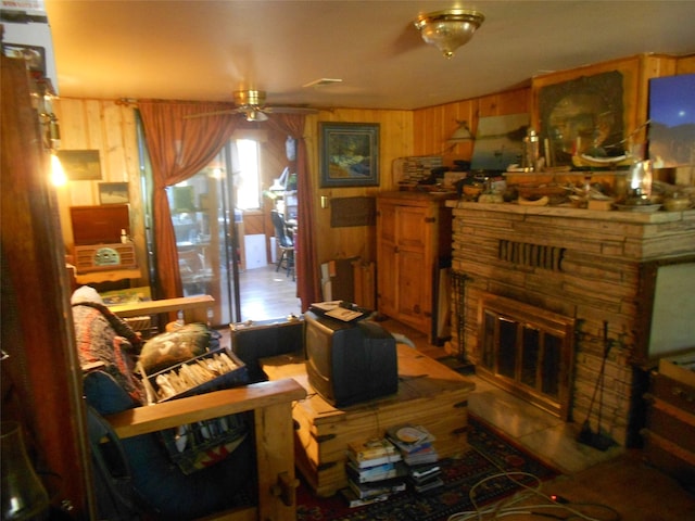 467 Cooper Ln, Hamilton, MT 59840 - living room featuring wood walls, a ceiling fan, and a fireplace