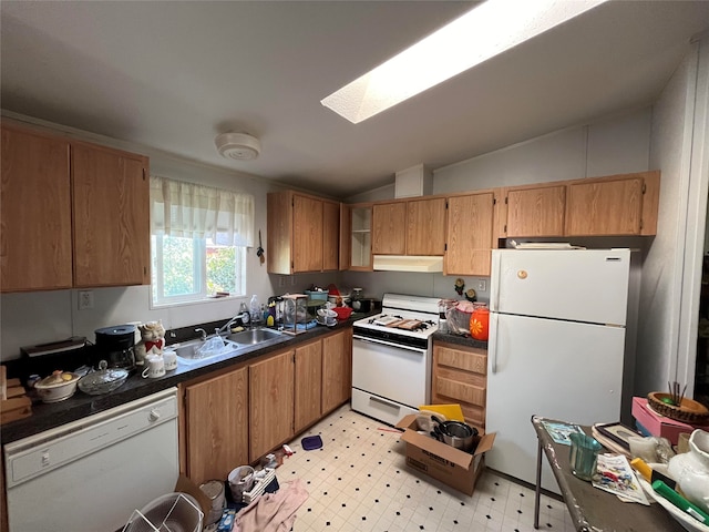 kitchen featuring sink, white appliances, light tile patterned flooring, and lofted ceiling with skylight