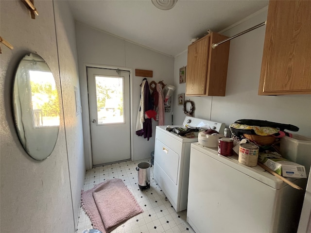 washroom with washing machine and clothes dryer, cabinets, and light tile patterned flooring