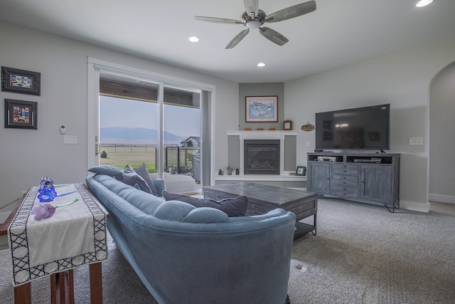 carpeted living room featuring ceiling fan