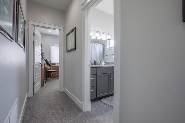 hall with light carpet and sink