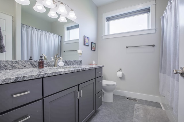 bathroom featuring vanity, toilet, and curtained shower