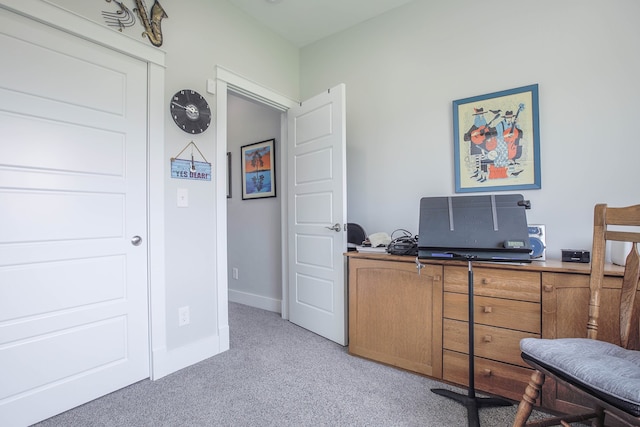 office area featuring light carpet