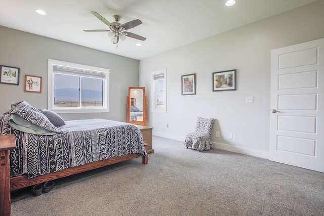 bedroom featuring ceiling fan and carpet