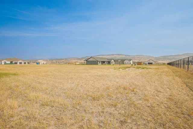 view of yard featuring a mountain view and a rural view