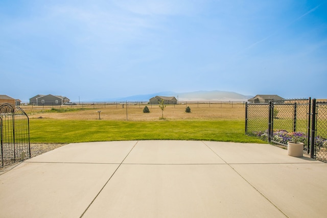 view of patio / terrace featuring a mountain view and a rural view