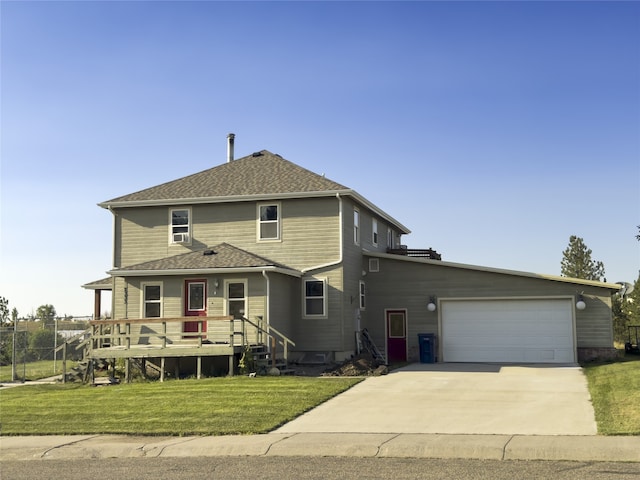 view of front of house with a garage, a front yard, concrete driveway, and a shingled roof