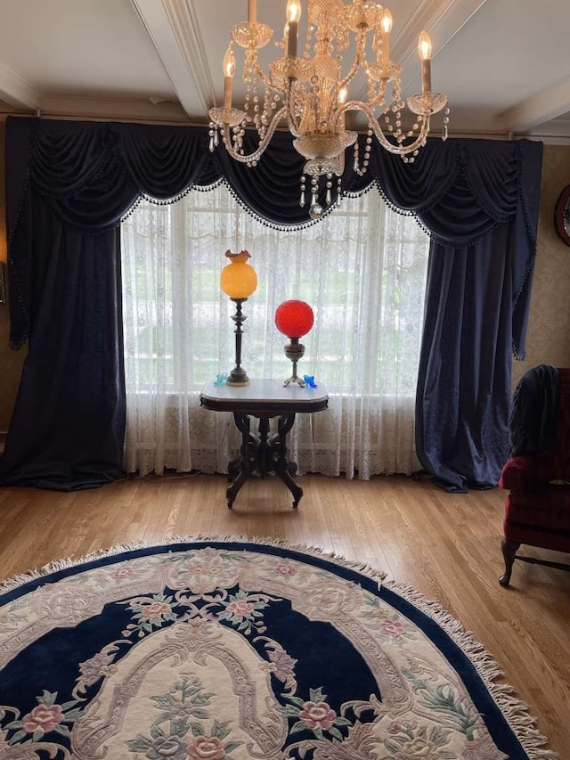 dining space with ornamental molding, wood-type flooring, and a chandelier