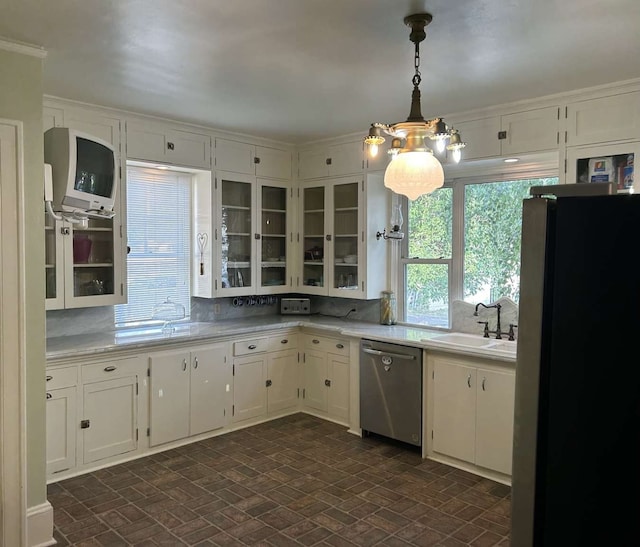 kitchen with dishwasher, decorative light fixtures, a chandelier, black refrigerator, and tasteful backsplash