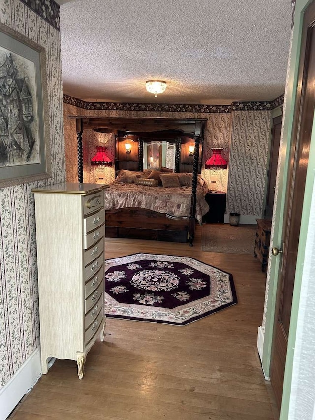 bedroom with a textured ceiling and hardwood / wood-style floors