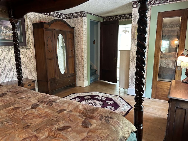 bedroom with a textured ceiling and hardwood / wood-style floors