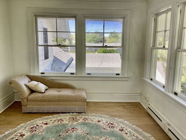 sitting room with hardwood / wood-style flooring and a baseboard radiator