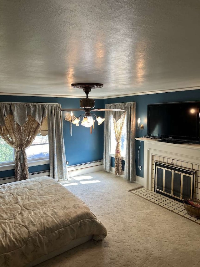 unfurnished bedroom featuring ornamental molding, a textured ceiling, baseboard heating, ceiling fan, and carpet flooring