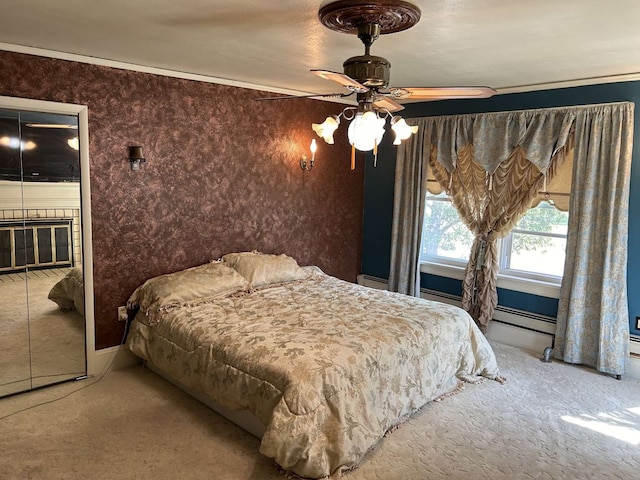 bedroom with ceiling fan, a baseboard radiator, and carpet