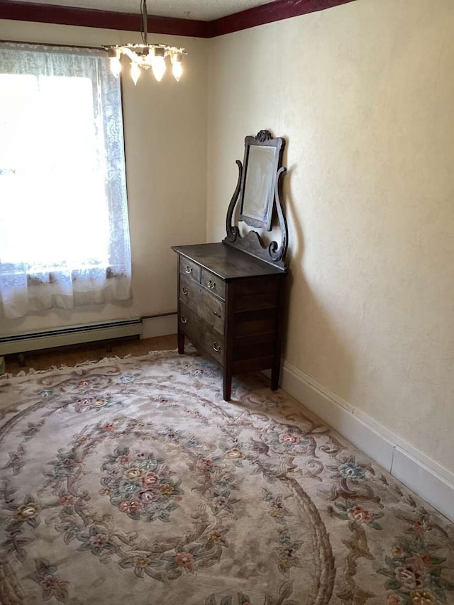 interior space with an inviting chandelier and a baseboard radiator