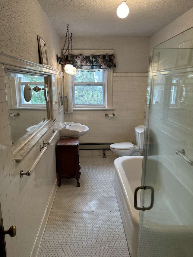 full bathroom featuring tile patterned flooring, toilet, independent shower and bath, vanity, and a textured ceiling